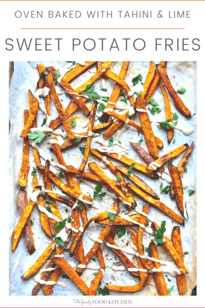 Pinnable image with recipe title and roasted sweet potato fries  on a sheet pan drizzled with creamy tahini sauce and garnished with freshly chopped parsley.