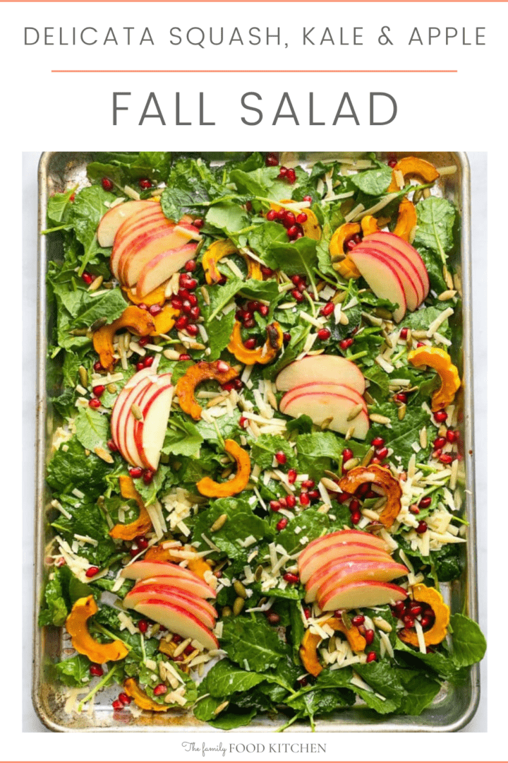 Pinnable image with recipe title and sheet pan with roasted squash, fresh kale, green leaves, sliced red apple, grated cheese, pumpkin seeds and pomegranate seeds.