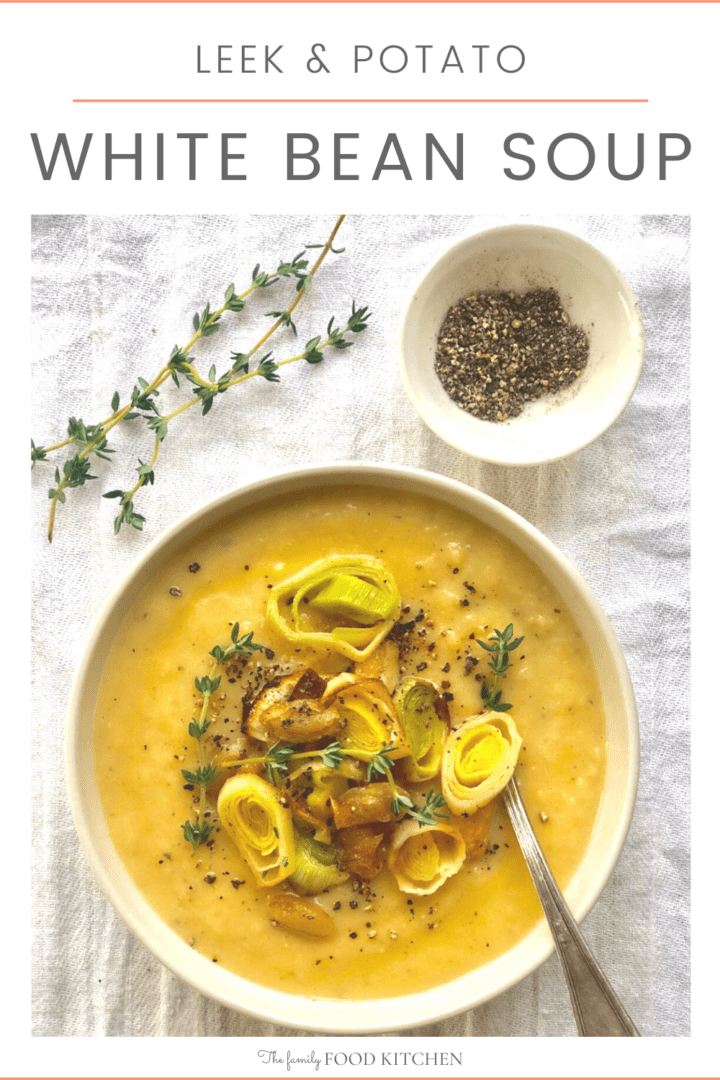 Pinnable image with recipe title showing bowl of white bean soup and potato soup topped with sliced leeks and garnished with sprigs of fresh thyme with a pinch pot of black pepper alongside.