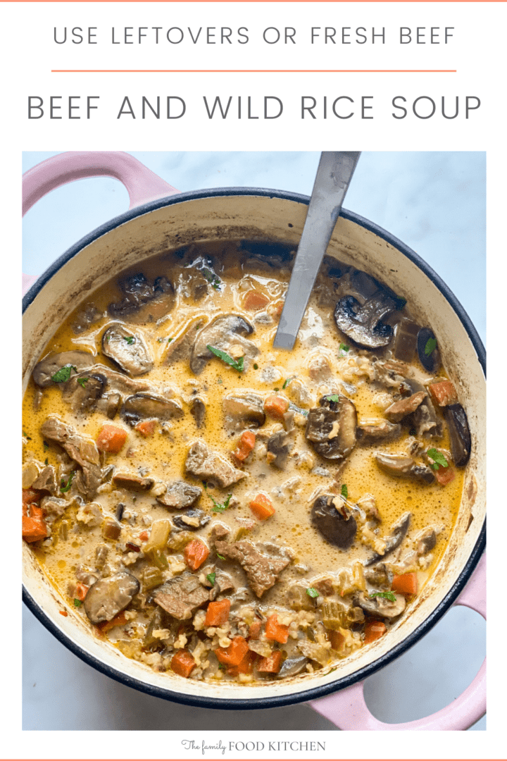Pinnable image with recipe title and large pot of creamy soup with chunks of roast beef, diced carrots and sliced mushrooms.