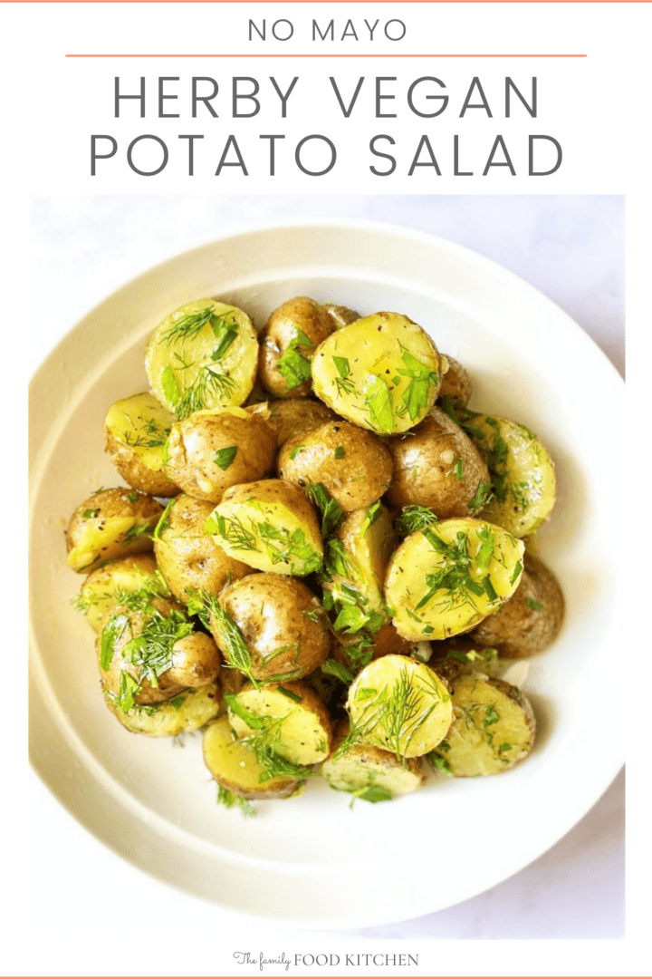 Pinnable image with recipe title and white bowl of cooked new potatoes coated in a fresh herb salad dressing.