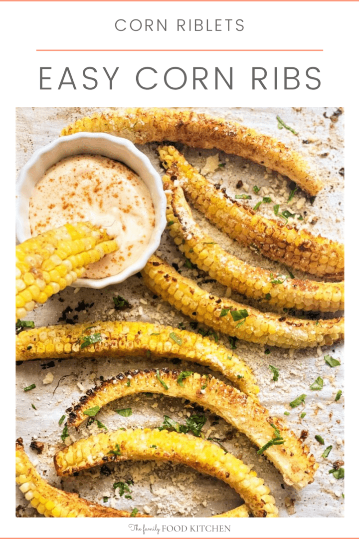 Pinnable image with recipe title and baked corn ribs on a sheet pan with a bowl of spicy mayonnaise.