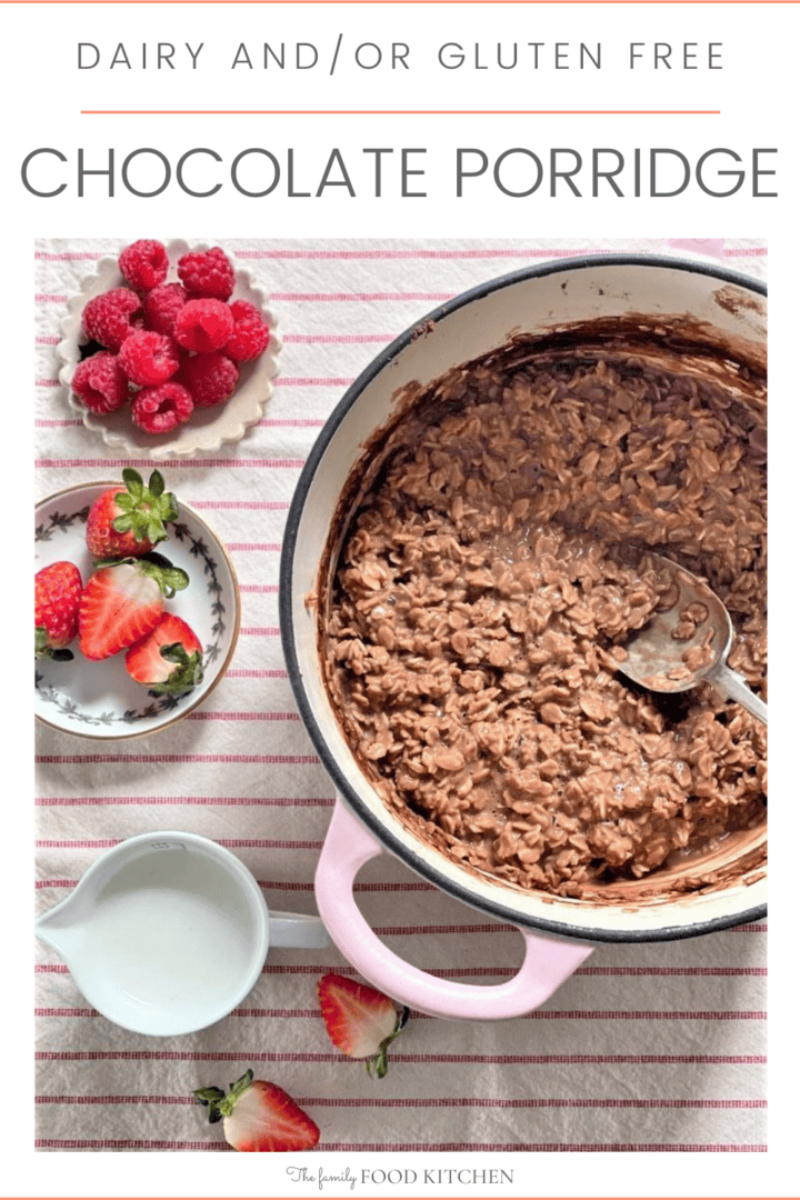 Pinnable image with recipe title and pot of chocolate porridge with jug of milk and bowls of raspberries and strawberries.