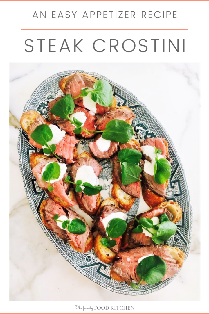 Pinnable graphic showing an oval platter of steak crostini from above with the recipe title name shown in text. 