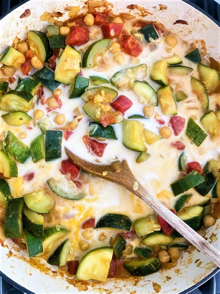 Pan containing cooked zucchini curry base with added coconut milk