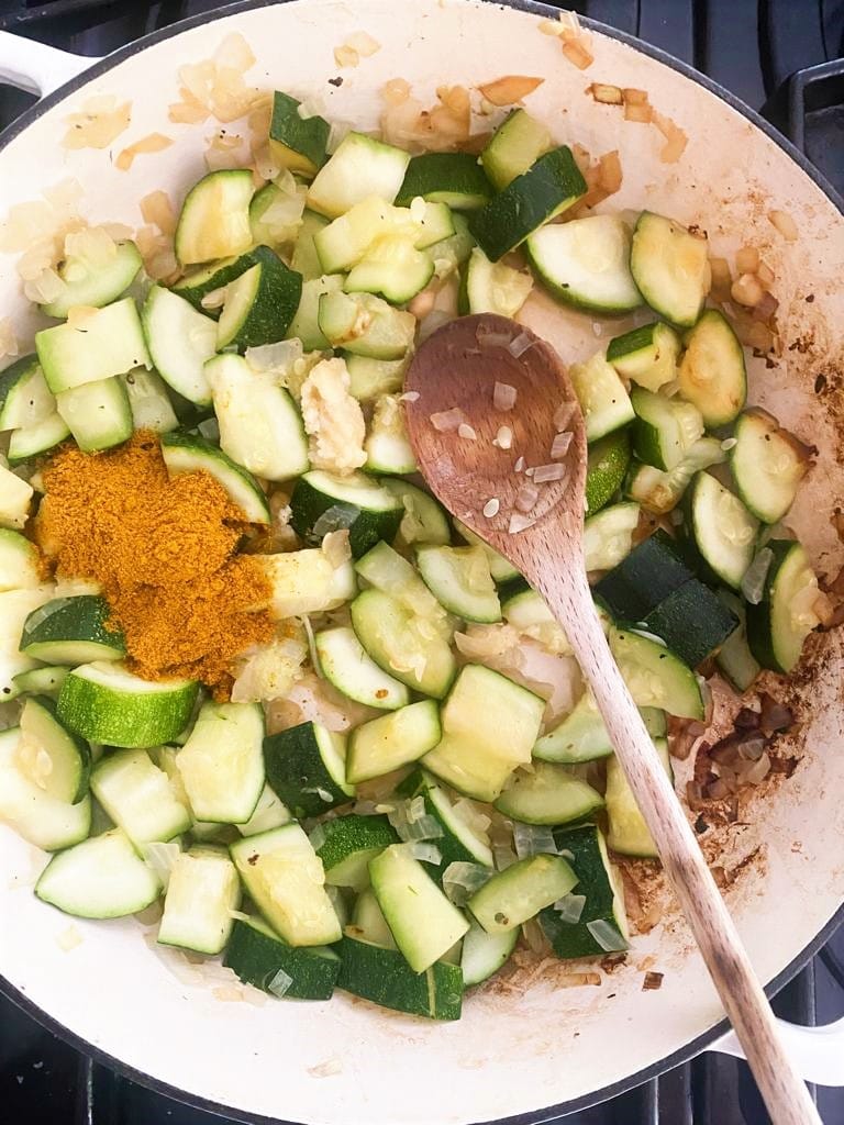 Pan with sauted zucchini, onions and added garam masala spice