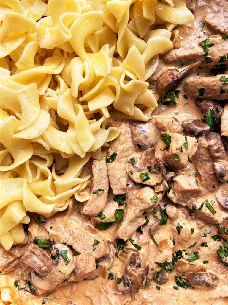 Close up image of Easy Pork Stroganoff and buttered noodles