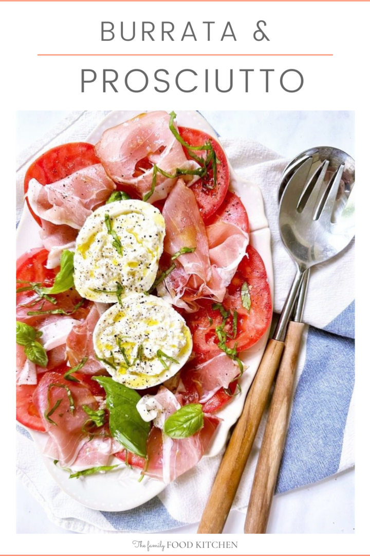 Pinnable image with recipe title and platter of burrata and prosciutto salad with sliced tomatoes, finely chopped basil and dressed with olive oil and freshly ground black pepper.