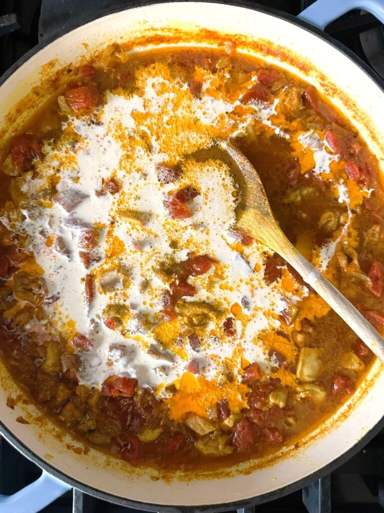 A Dutch oven of chicken tikka masala soup with added coconut milk.