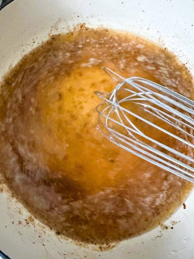 A Dutch oven with reduced beef and onion gravy.