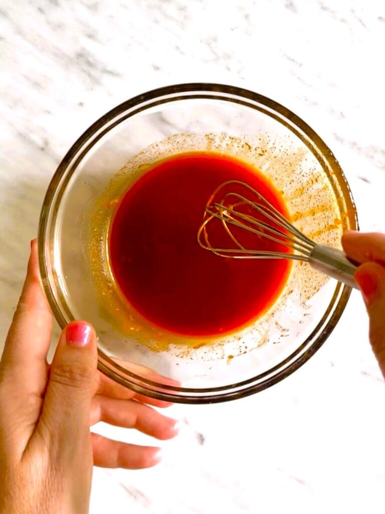 A glass bowl of combined gochujang sauce ingredients.