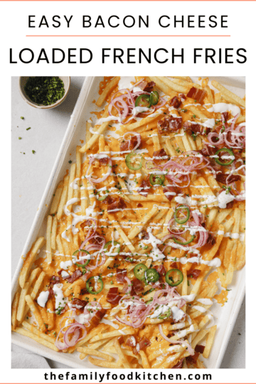 Pinnable image with recipe title and a lined baking sheet topped with golden French fries, crispy bacon pieces, melted cheese, pickled red onions and jalapenos, with a Greek yogurt drizzle and garnished with chopped chives.