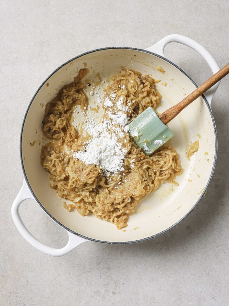 A large skilled of caramelized onions with added cornstarch.