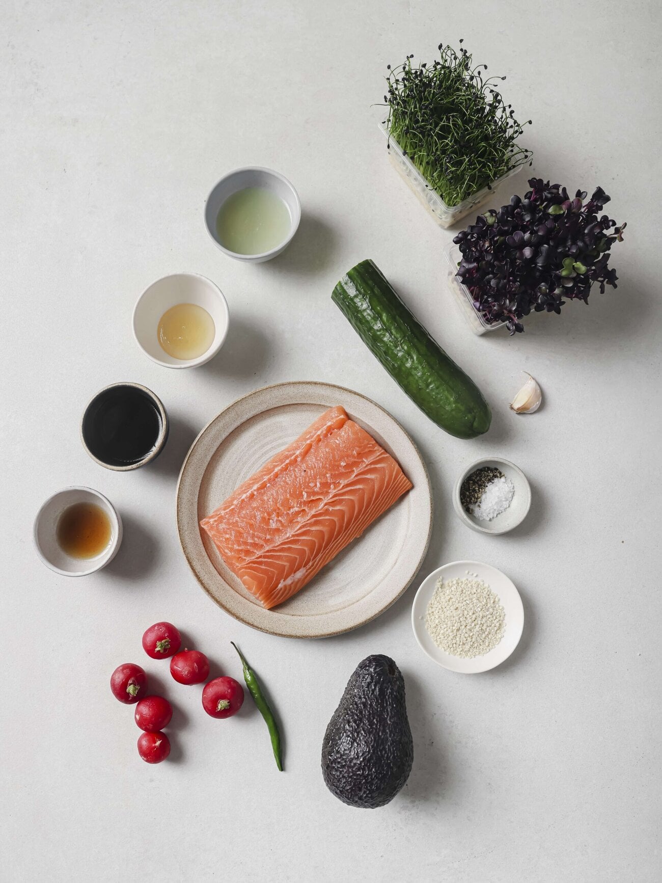 Individual recipe ingredients for making salmon crudo bowl.