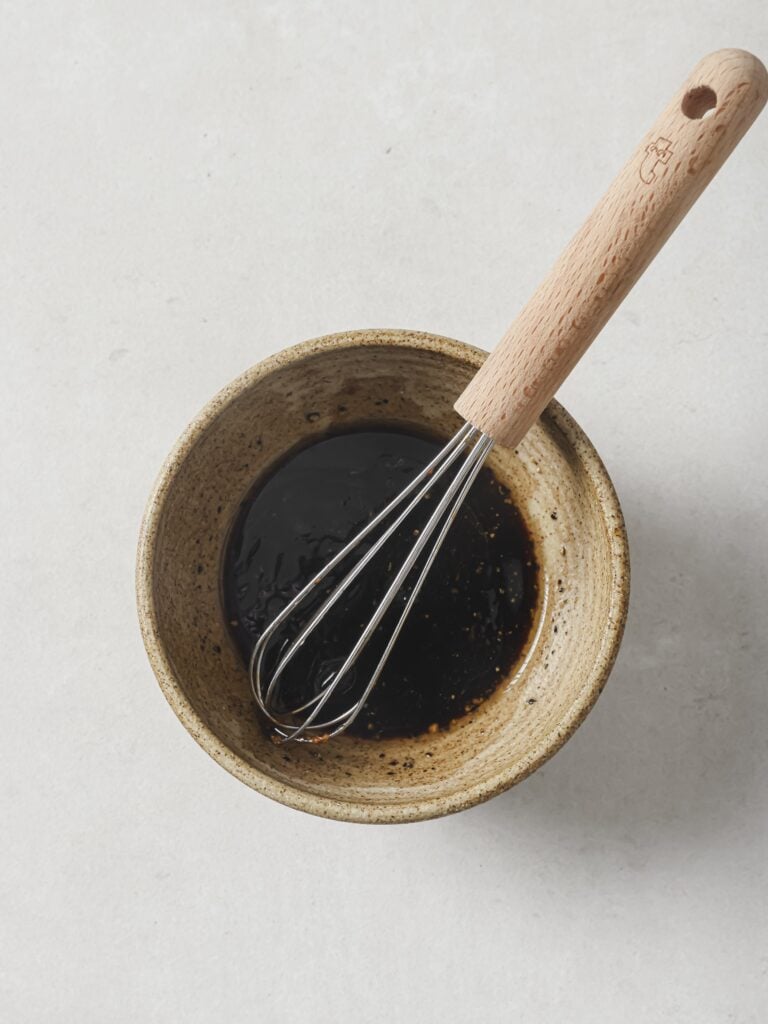 A small bowl of soy-lime honey dressing.