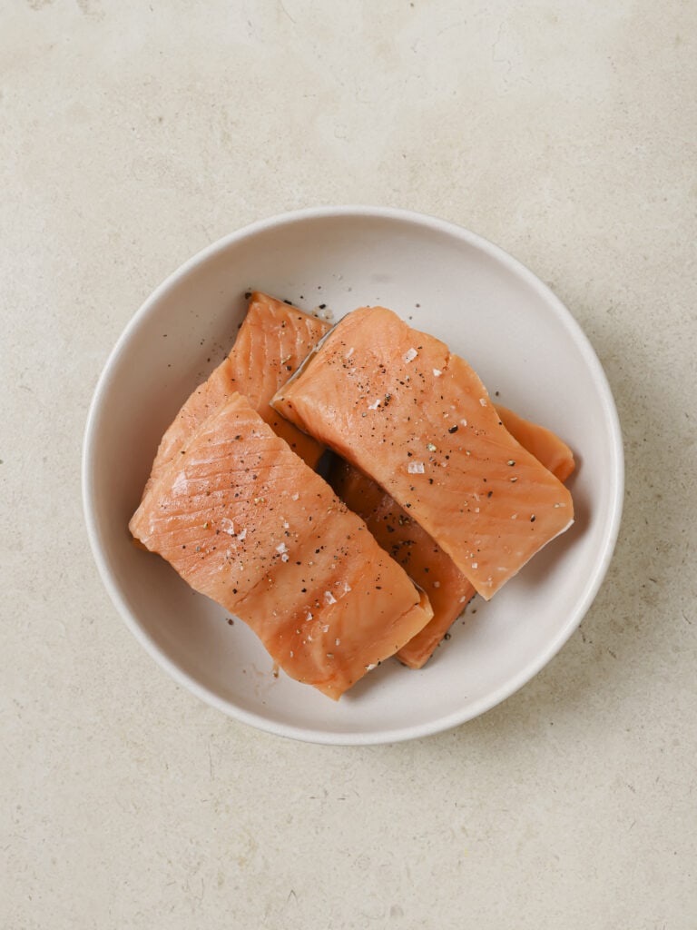 A place with 4 raw salmon filets.