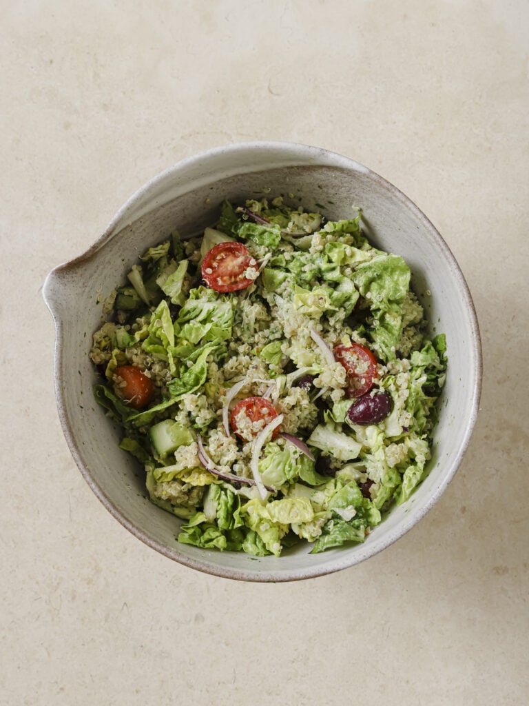A bowl of dressed mixed salad.