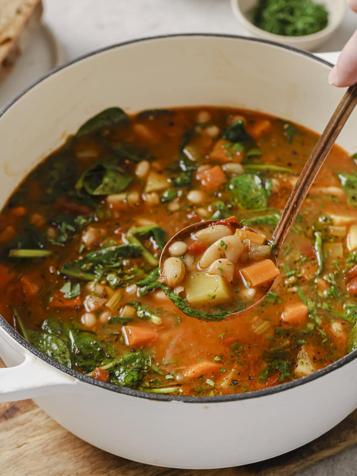Close-up of Ikarian bean stew with spinach, carrot and tomato