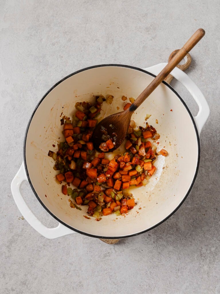 Softened vegetables stirred with garlic, oregano and tomato paste