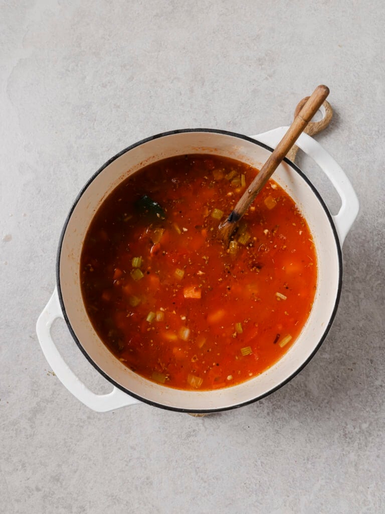 Canned tomatoes, broth, potato and beans added to the pot for Ikarian stew