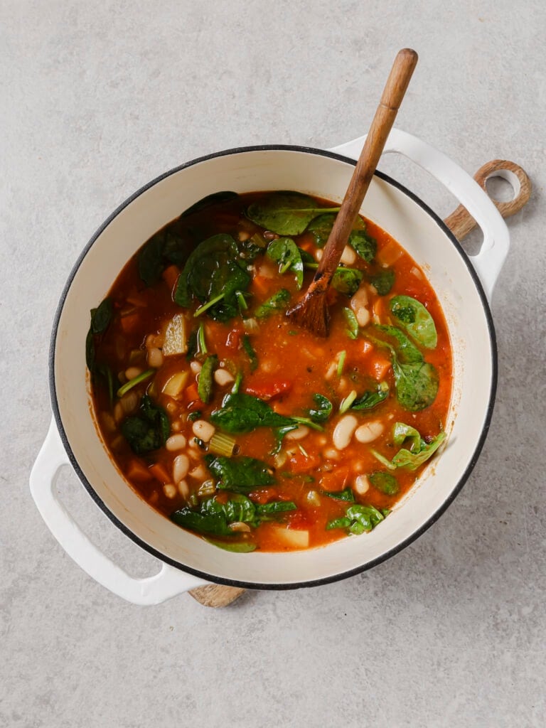 Baby spinach stirred into the simmered white bean stew